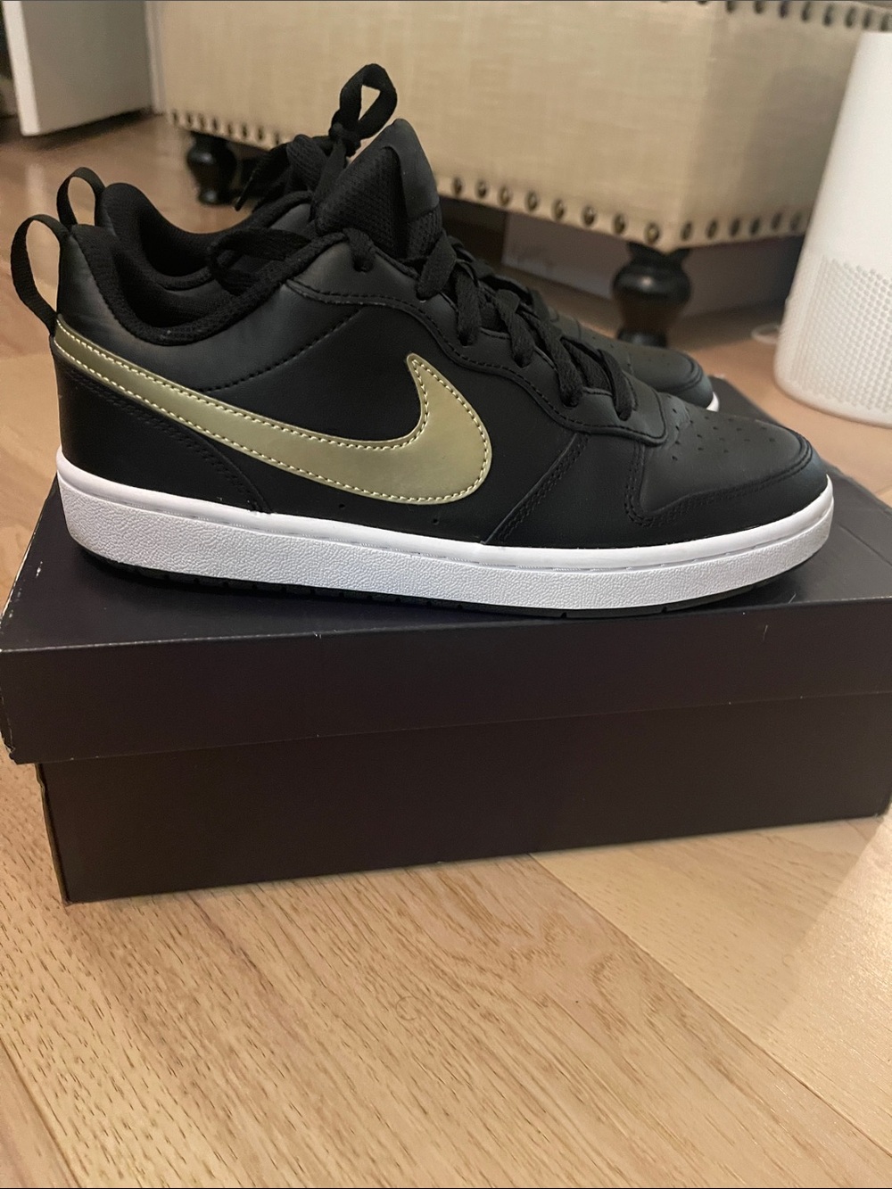 Nike Black Low-Top Sneakers with Gold Swoosh